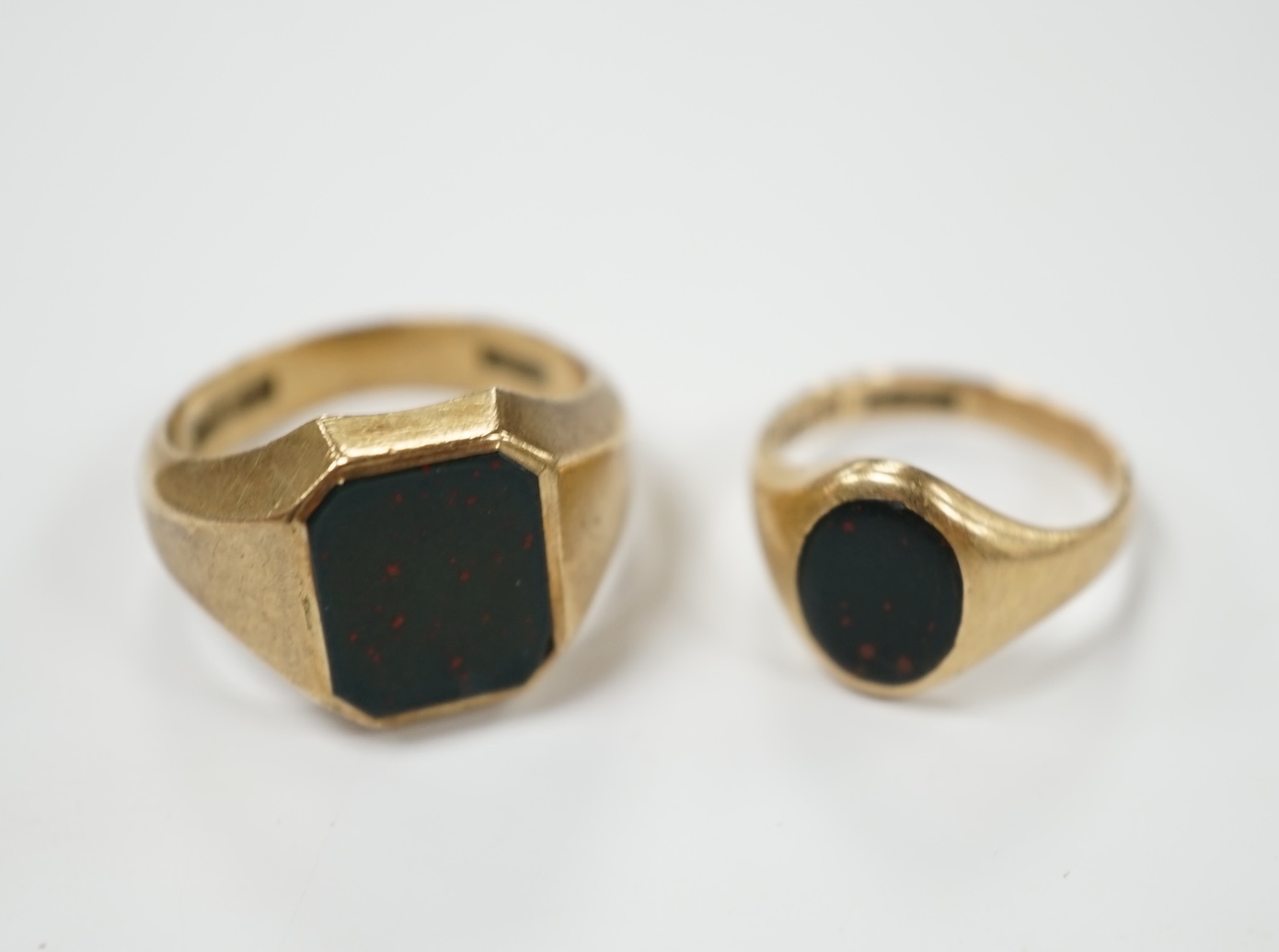 Two 9ct gold and bloodstone set signet rings, largest size Q, gross weight 11.5 grams. Condition - poor to fair